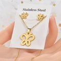Detail of golden butterfly necklace and earrings set in stainless steel on a white tulle - Gold Butterfly