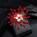 Detailed view of handmade snowflake brooch with red crystals and pearls on black display - Red and White Beaded Style (Style 7)