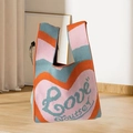 Knitted handbag with orange and pink wave pattern and Love Yourself heart design - Red Heart