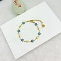 Bracelet élégant en plaqué or 18k avec marguerites et étoiles sur fond en marbre - Bleu Or