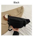 Detail of minimalist black nylon sling bag featuring high-quality zippers and woven pullers - Black