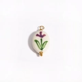 Detailed view of an oval white ceramic pendant with hand-painted purple flowers and 18K gold - Purple Floral Oval (Style 4)