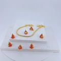 Close-up of golden snake chain bracelet with red and gold cone-shaped enamel charms - Red/Gold