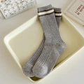 Light gray knit crew socks featuring two horizontal stripes and ribbed texture on tray - One Size / Speckled Gray