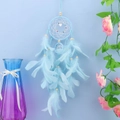 Blue dream catcher with feathers and heart pendant hanging on a light blue wall decoration - Standard Type / Blue