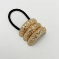 Close-up of golden hammered alloy u-shaped hair tie with black elastic band detail - Sand Rose Gold Triple Design