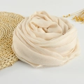 Elegant beige cotton linen scarf with frayed edges styled in a floral shape on white background - 190x100cm / Cream White