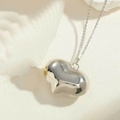 Macro shot of polished heart pendant with reflective finish on delicate silver chain - Large (2.5cm) / Silver