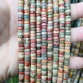 Detailed close-up of colorful natural stone heishi beads for DIY jewelry making - Picasso Jasper