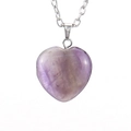 Detailed close-up of a faceted heart-shaped purple natural stone pendant with silver chain - Purple Crystal