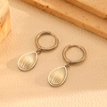 Detailed close-up of silver drop earrings with shell texture inlays on leather surface - Steel Color Water Drop Shell Hoop Earrings (H217)
