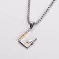 Detailed view of silver and gold stainless steel book locket pendant with heart cutout - Gold