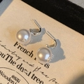Detailed close-up of C-shaped pearl earrings with zircon star on silver needles - Silver (S925 Silver Needle)