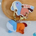Cute blue and orange soft rubber whale keychain with a golden metal hook pendant - Flatterer (Funny Whale)
