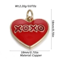 Detail view of a red enamel heart pendant in copper with gold trim and XOXO engraving - Red XOXO Heart