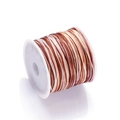 Macro detail of gradient brown and beige 72# nylon cord on white spool for DIY jewelry - Color No. 22