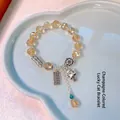 Champagne crystal beaded bracelet with lucky bells and peanuts in a heart-shaped tray - Champagne Crystal Peanut Abacus Fortune Cat Bracelet
