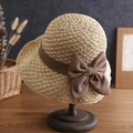 Close-up of beige straw sun hat featuring a dark brown bow on a wooden stand - L (58-60cm) / Burlap Bow Decor Beige