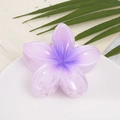 Floral hair claw clip with purple gradient petals on a white decorative plate - Purple Plumeria