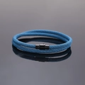 Close-up of blue braided cord bracelet with black magnetic clasp and double-loop design - Teal