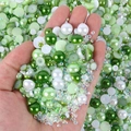 Macro shot of mixed green and white flatback pearls and rhinestones for nail art DIY - Half-circle Pearl Green And White Series #a04 / 30 g