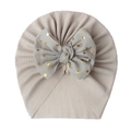 Detail of baby turban hat with ribbed knit fabric and grey mesh bow with gold dots - Gray