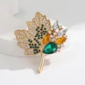 Golden maple leaf brooch featuring green crystals and sparkling rhinestones - Green (HC1138)