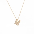 Detail of gold letter M pendant with micro-paved zircons on a delicate choker chain - Letter M
