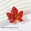 Maple leaf brooch featuring red gradient crystals and a golden alloy finish - Red Maple Leaves