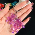 Close-up of three purple resin gummy bear charms with silver keychain metal rings - Purple