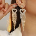 Luxury gold heart earrings with dangling rhinestone tassels worn by a model - Gold Heart Long Tassel Style (DTE1816403GL-W)