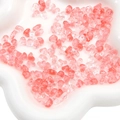 Pink and clear irregular acrylic mixed beads displayed on a white wavy ceramic tray - Transparent Watermelon Red