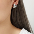 Polished silver heart stud earring worn by model showing a minimalist geometric style - Small (F1072) / Silver