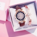 Close-up of rose gold watch with floral diamond dial and matching star charm bracelet - Floral Watch + Bracelet Set / Brown