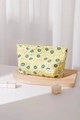 Detalle de neceser de flores amarillas con tela texturizada y etiqueta de marca - Amarillo Grande