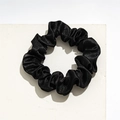 Detailed view of black satin scrunchie with soft elastic pleated texture on white block - Small Satin Black