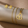 Polished gold stainless steel jewelry set featuring hollow heart and cross pendants - Heart with Cross (TZ-489)