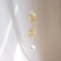 Detailed view of golden lucky clover suncatcher reflecting rainbow light spots - A30-Double Four-Leaf Clover