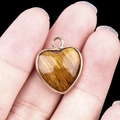 Tiger eye stone heart pendant with gold plated bezel and a top ring loop - Tiger Eye Gold Edging