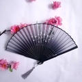 Bamboo folding fan with black bamboo and plum blossom motifs and a grey tassel - Dark Gradient Ink Bamboo & White Plum Style (Women's Fan-47)