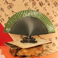 Dark green Chinese folding fan with pink cherry blossoms and black bamboo ribs on stand - 42 Square Hollow Raindrop Green Flowers