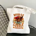 Nurse Gobble Squad white canvas tote bag with turkey graphic on metal mesh chair - Style C18 (No Inner Pocket/No Zipper)