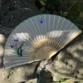 Silk folding fan with blue iris embroidery, bamboo frame and dark green tassel decoration - Orchid and Butterfly