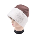Detailed close-up of brown and beige lamb wool bucket hat with soft plush textures - Camel