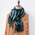 Detail of soft winter scarf featuring black and dark green stripes with fringe tassel ends - 185*65cm / Malachite green