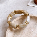 Detail of marble resin beads and gold metal spacers on stone tray and linen background - 14# Bangle-White-Square