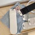 Close-up of premium combed cotton crew socks in neutral tones on denim jeans - One Size / White