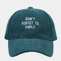 Close-up of white letter embroidery on dark green corduroy fabric baseball cap - Adjustable / Malachite green