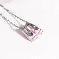 Detailed macro view of delicate pink enamel ballet shoe pendants on a silver chain - Platinum Pink
