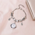 Silver beaded charm bracelet watch with owl pendant and crystals on pink silk background - White
